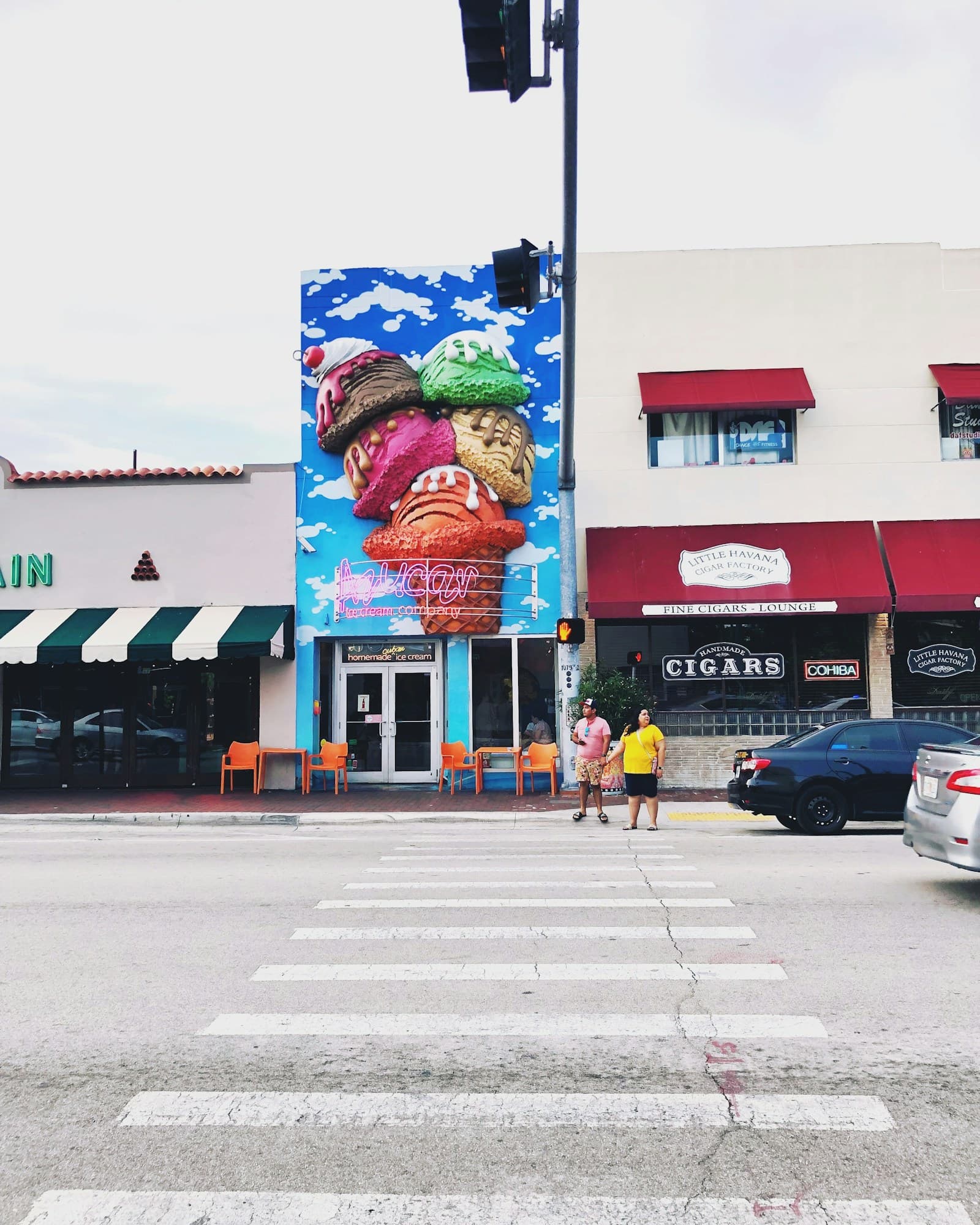 Couple walking on Calle Ocho sidewalk, Little Havana